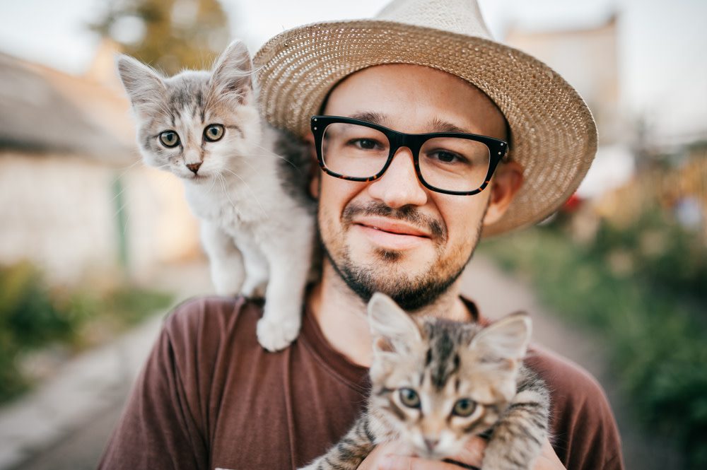 man with his two cats
